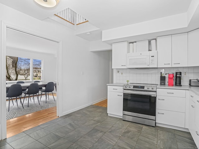 465 Edward St, Fairfield, CT 06824 - kitchen featuring stainless steel electric range oven, white microwave, light countertops, white cabinetry, and tasteful backsplash