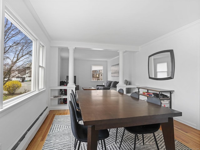 465 Edward St, Fairfield, CT 06824 - dining area featuring decorative columns, a baseboard heating unit, light wood-type flooring, healthy amount of natural light, and crown molding