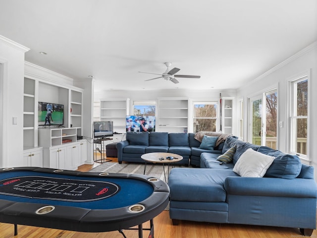 465 Edward St, Fairfield, CT 06824 - living area featuring crown molding, healthy amount of natural light, wood finished floors, ceiling fan, and built in features
