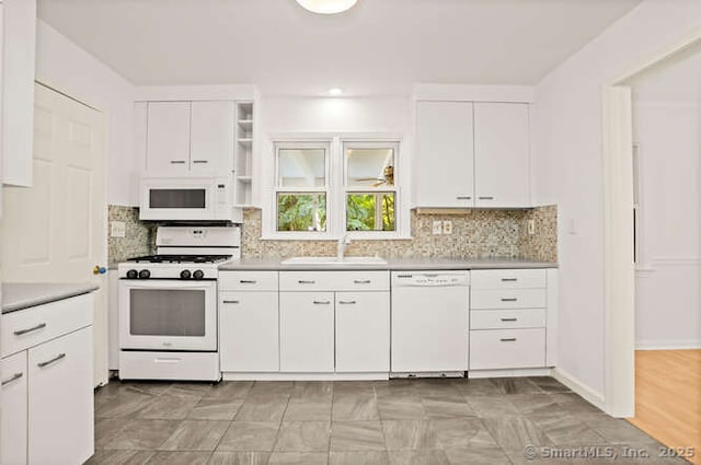 465 Edward St, Fairfield, CT 06824 - kitchen featuring white appliances, white cabinets, decorative backsplash, and light countertops