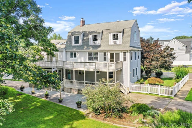 465 Edward St, Fairfield, CT 06824 - back of house featuring a gambrel roof, a chimney, a deck, a patio, and roof with shingles