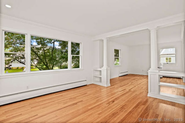 465 Edward St, Fairfield, CT 06824 - spare room featuring ornate columns, a baseboard heating unit, crown molding, and wood finished floors