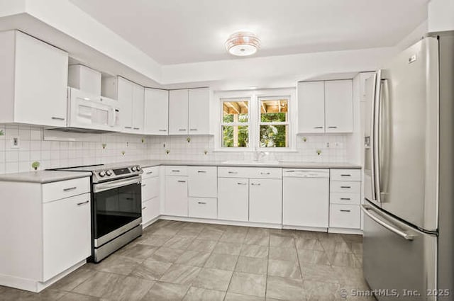 465 Edward St, Fairfield, CT 06824 - kitchen with stainless steel appliances, light countertops, decorative backsplash, and white cabinets