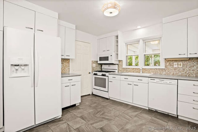465 Edward St, Fairfield, CT 06824 - kitchen with white appliances, white cabinets, open shelves, light countertops, and backsplash