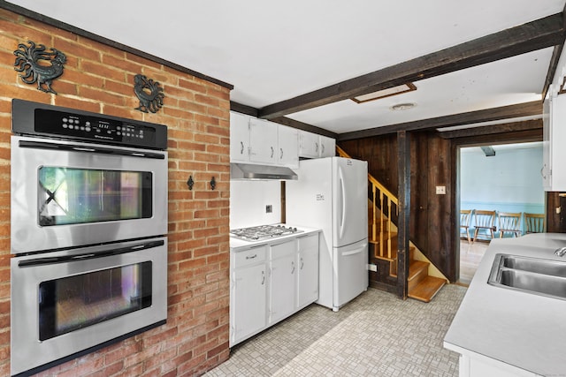 905 Meriden Ave, Southington, CT 06489 - kitchen featuring double oven, freestanding refrigerator, under cabinet range hood, light countertops, and beam ceiling