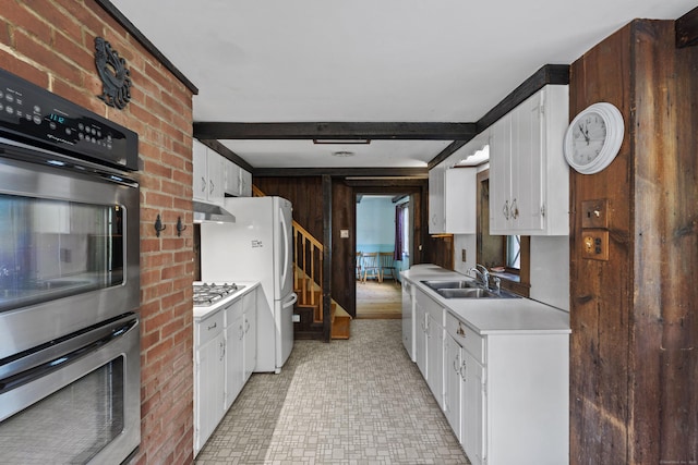 905 Meriden Ave, Southington, CT 06489 - kitchen featuring light countertops, white cabinetry, white appliances, wooden walls, and under cabinet range hood