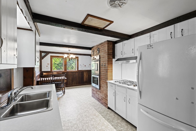 905 Meriden Ave, Southington, CT 06489 - kitchen featuring freestanding refrigerator, beamed ceiling, under cabinet range hood, double oven, and white cabinetry