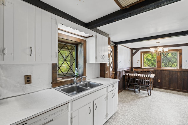 905 Meriden Ave, Southington, CT 06489 - kitchen with white dishwasher, light countertops, wood walls, a chandelier, and healthy amount of natural light