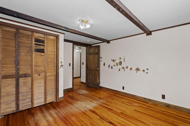 905 Meriden Ave, Southington, CT 06489 - unfurnished bedroom with beamed ceiling, hardwood / wood-style floors, and a closet