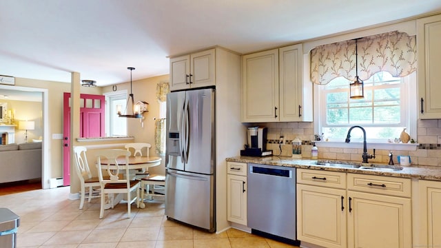 3 Lower Lake Rd, Danbury, CT 06811 - kitchen with appliances with stainless steel finishes, cream cabinetry, decorative backsplash, and hanging light fixtures
