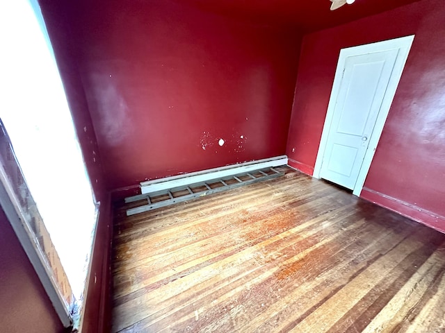 155 Waverly Rd, Shelton, CT 06484 - spare room with wood finished floors and a baseboard heating unit