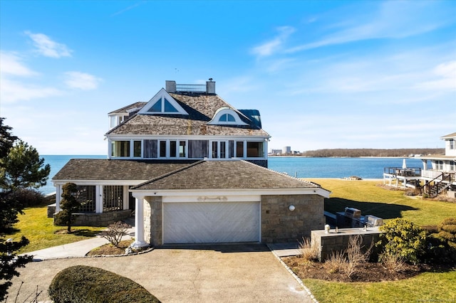 33 Palmer Rd, Waterford, CT 06385 - view of front facade featuring a water view, concrete driveway, a chimney, and a garage
