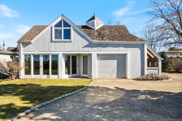 33 Palmer Rd, Waterford, CT 06385 - back of house with a garage, driveway, a lawn, and french doors