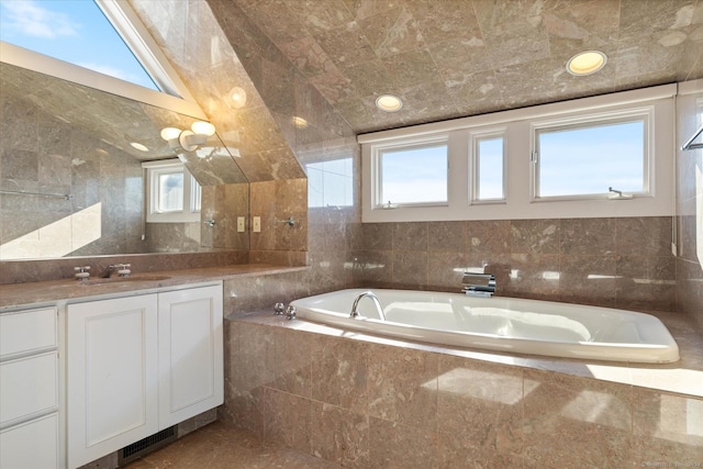 33 Palmer Rd, Waterford, CT 06385 - bathroom with vanity, a garden tub, and tile walls