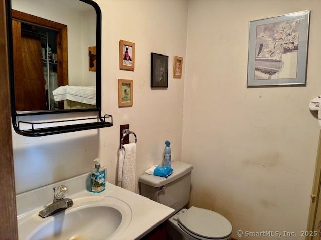 77 Plains Rd, Windham, CT 06280 - bathroom featuring toilet and vanity
