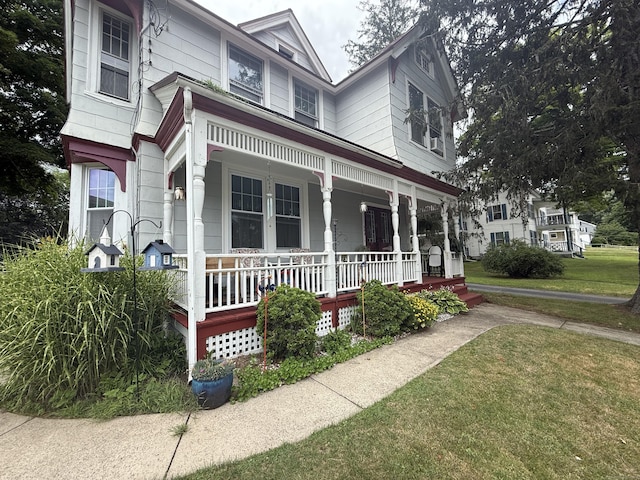 352 Church St, Putnam, CT 06260 - victorian home featuring a porch and a front lawn