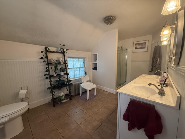 352 Church St, Putnam, CT 06260 - bathroom with lofted ceiling, a wainscoted wall, tile patterned flooring, double vanity, and a shower stall