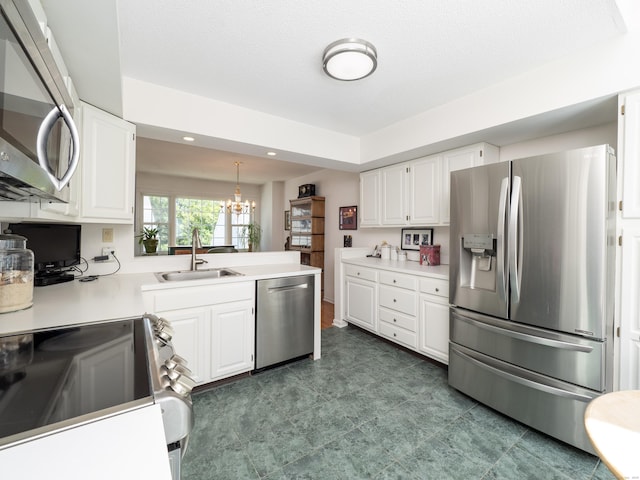 26 Wilton Crst Unit 26, Wilton, CT 06897 - kitchen with stainless steel appliances, a chandelier, white cabinets, light countertops, and recessed lighting