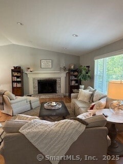 1 Brookfield Rd, Harwinton, CT 06791 - living area featuring lofted ceiling, wood finished floors, and a fireplace with raised hearth