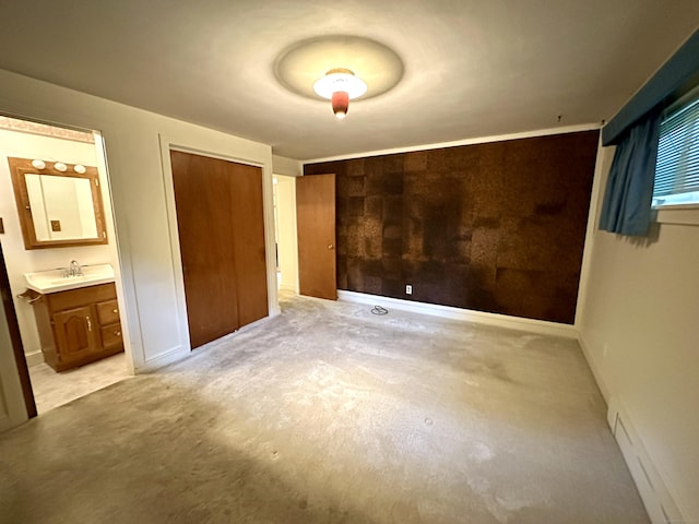 23 S Elm St, Windsor Locks, CT 06096 - unfurnished bedroom featuring light colored carpet, baseboard heating, ensuite bathroom, and a closet