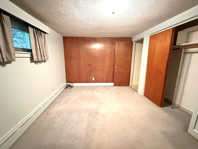 23 S Elm St, Windsor Locks, CT 06096 - unfurnished bedroom with a baseboard radiator, a textured ceiling, and light carpet
