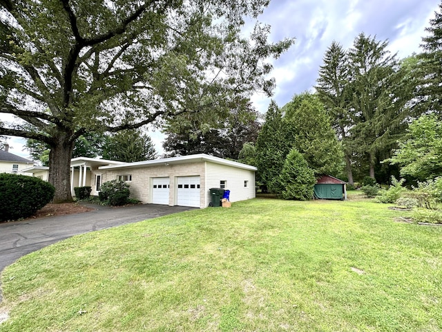 23 S Elm St, Windsor Locks, CT 06096 - view of grassy yard with asphalt driveway and a garage