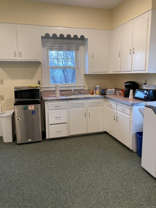 21 Chicago Ave, Groton, CT 06340 - kitchen featuring white cabinetry and light countertops