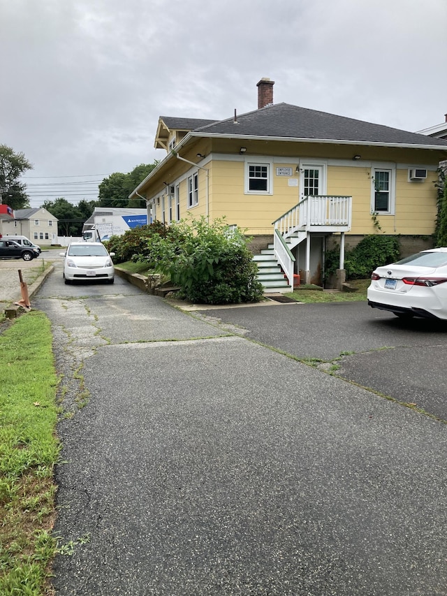 21 Chicago Ave, Groton, CT 06340 - view of side of property featuring a chimney and stairs