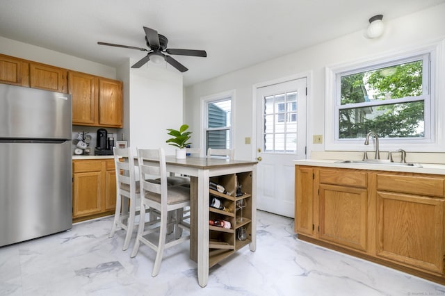 95 Elm St Apt 4, West Haven, CT 06516 - kitchen with freestanding refrigerator, light marble finish floors, light countertops, and plenty of natural light