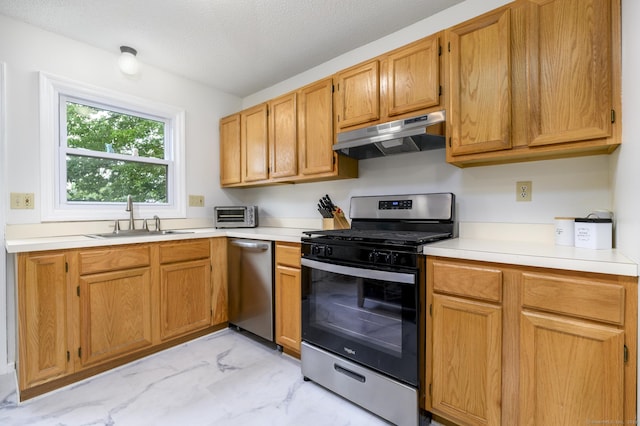 95 Elm St Apt 4, West Haven, CT 06516 - kitchen featuring appliances with stainless steel finishes, under cabinet range hood, light marble finish floors, light countertops, and a textured ceiling