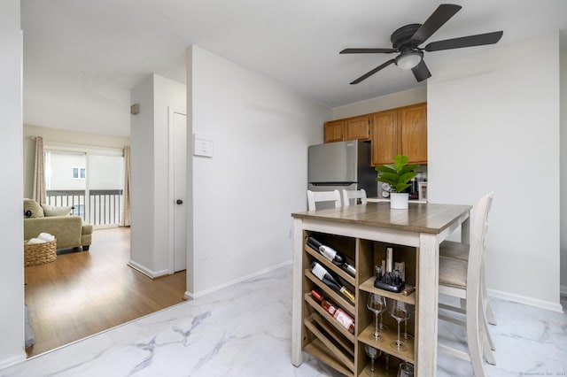 95 Elm St Apt 4, West Haven, CT 06516 - kitchen featuring ceiling fan, light marble finish floors, brown cabinets, and freestanding refrigerator