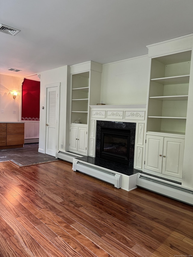 23 Mountain Rd, Mansfield, CT 06250 - unfurnished living room with built in shelves, a baseboard radiator, wood finished floors, and a high end fireplace