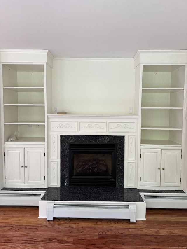 23 Mountain Rd, Mansfield, CT 06250 - detailed view of a baseboard heating unit, wood finished floors, and a high end fireplace