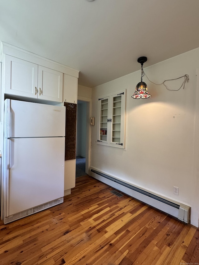 23 Mountain Rd, Mansfield, CT 06250 - kitchen with freestanding refrigerator, a baseboard heating unit, white cabinets, light wood-style flooring, and hanging light fixtures