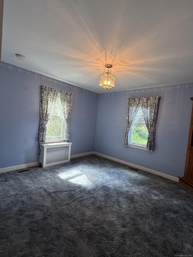 23 Mountain Rd, Mansfield, CT 06250 - spare room with radiator heating unit, carpet, and a chandelier