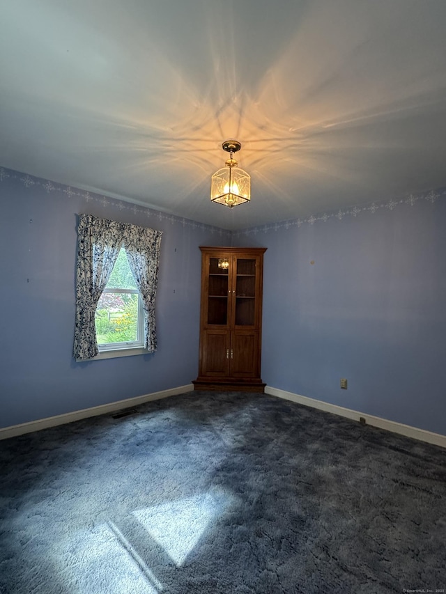 23 Mountain Rd, Mansfield, CT 06250 - unfurnished room featuring dark carpet and a chandelier