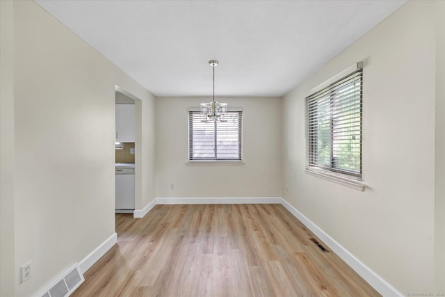 23 Happy Hollow Cir Unit B, Stratford, CT 06614 - unfurnished dining area featuring a chandelier, plenty of natural light, and light wood finished floors