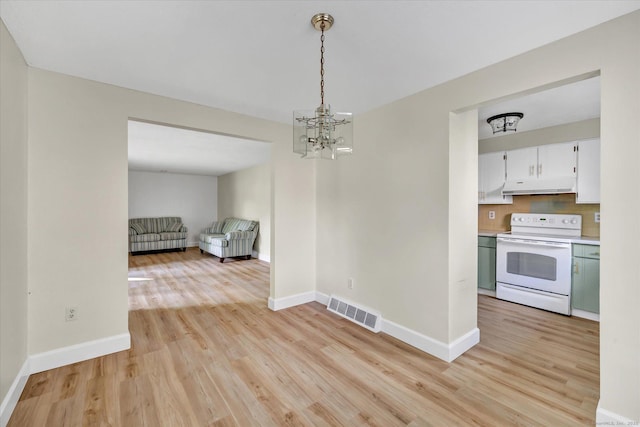 23 Happy Hollow Cir Unit B, Stratford, CT 06614 - unfurnished dining area with light wood finished floors and a chandelier