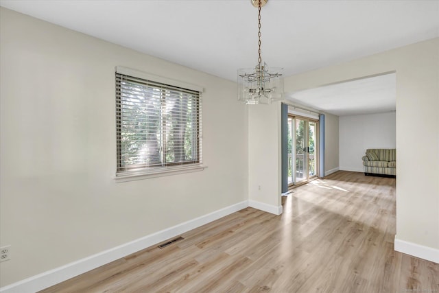 23 Happy Hollow Cir Unit B, Stratford, CT 06614 - unfurnished room featuring a chandelier and light wood-type flooring
