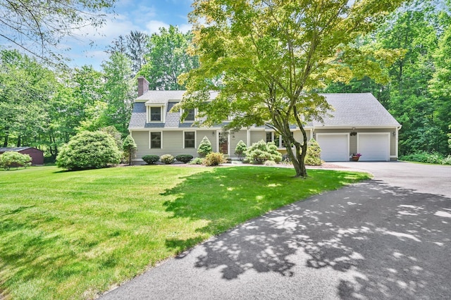 373 Broad Way, Coventry, CT 06238 - view of front of property with a garage, driveway, a chimney, and a front yard