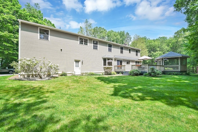 373 Broad Way, Coventry, CT 06238 - back of property featuring a wooden deck, a lawn, and a chimney