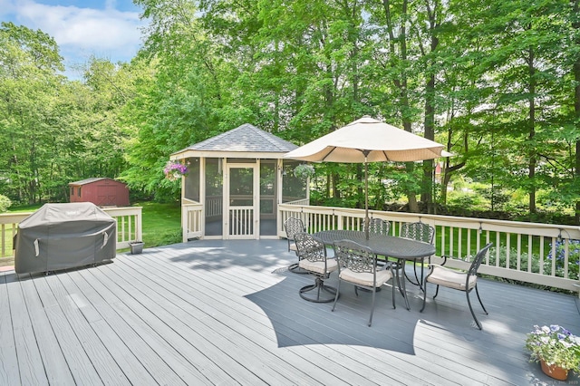 373 Broad Way, Coventry, CT 06238 - wooden terrace featuring a sunroom, outdoor dining area, area for grilling, and a storage unit