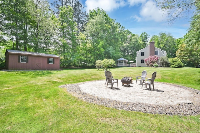 373 Broad Way, Coventry, CT 06238 - view of green lawn featuring an outdoor fire pit, an outdoor structure, and view of scattered trees