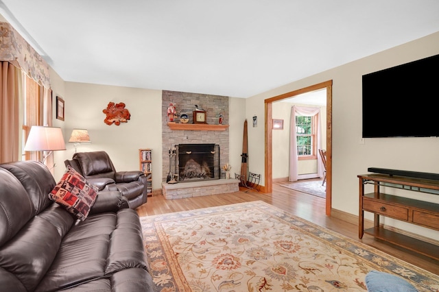 373 Broad Way, Coventry, CT 06238 - living room with light wood-type flooring, a fireplace, and a baseboard radiator