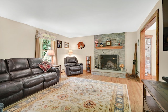 373 Broad Way, Coventry, CT 06238 - living area with wood finished floors, a stone fireplace, and baseboard heating