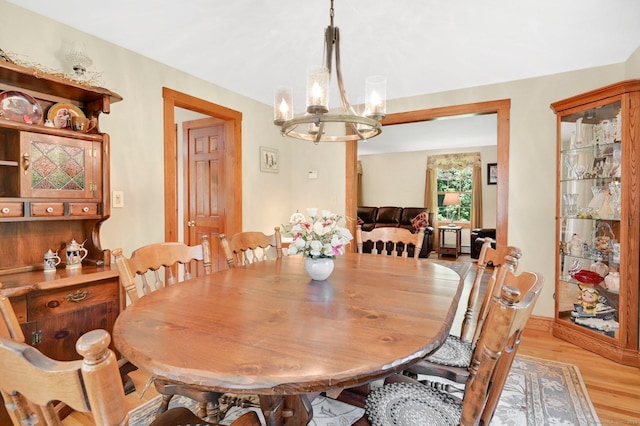 373 Broad Way, Coventry, CT 06238 - dining room featuring a chandelier and light wood-style floors