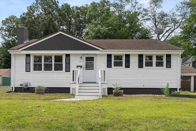 230 Green Rd, Manchester, CT 06042 - view of front of property featuring a front lawn, roof with shingles, and a chimney