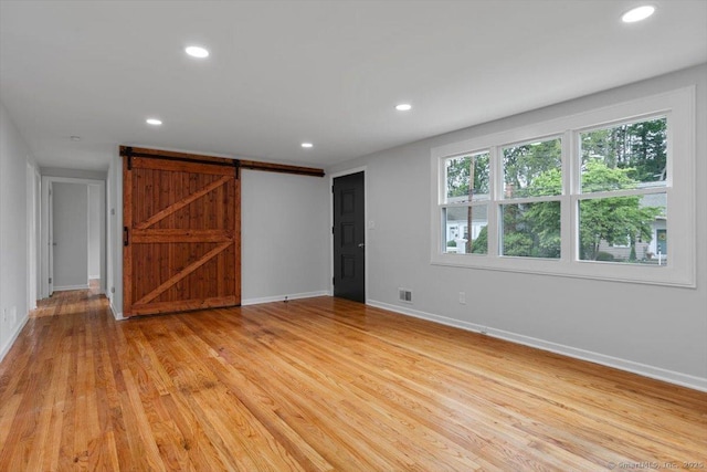230 Green Rd, Manchester, CT 06042 - empty room with recessed lighting, light wood-style floors, and a barn door