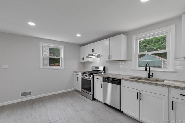 230 Green Rd, Manchester, CT 06042 - kitchen featuring stainless steel appliances, backsplash, under cabinet range hood, light stone counters, and recessed lighting