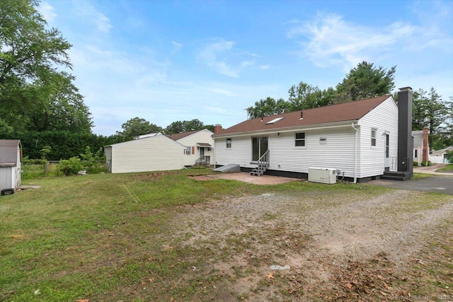 230 Green Rd, Manchester, CT 06042 - rear view of property featuring entry steps, a chimney, a lawn, and a shed